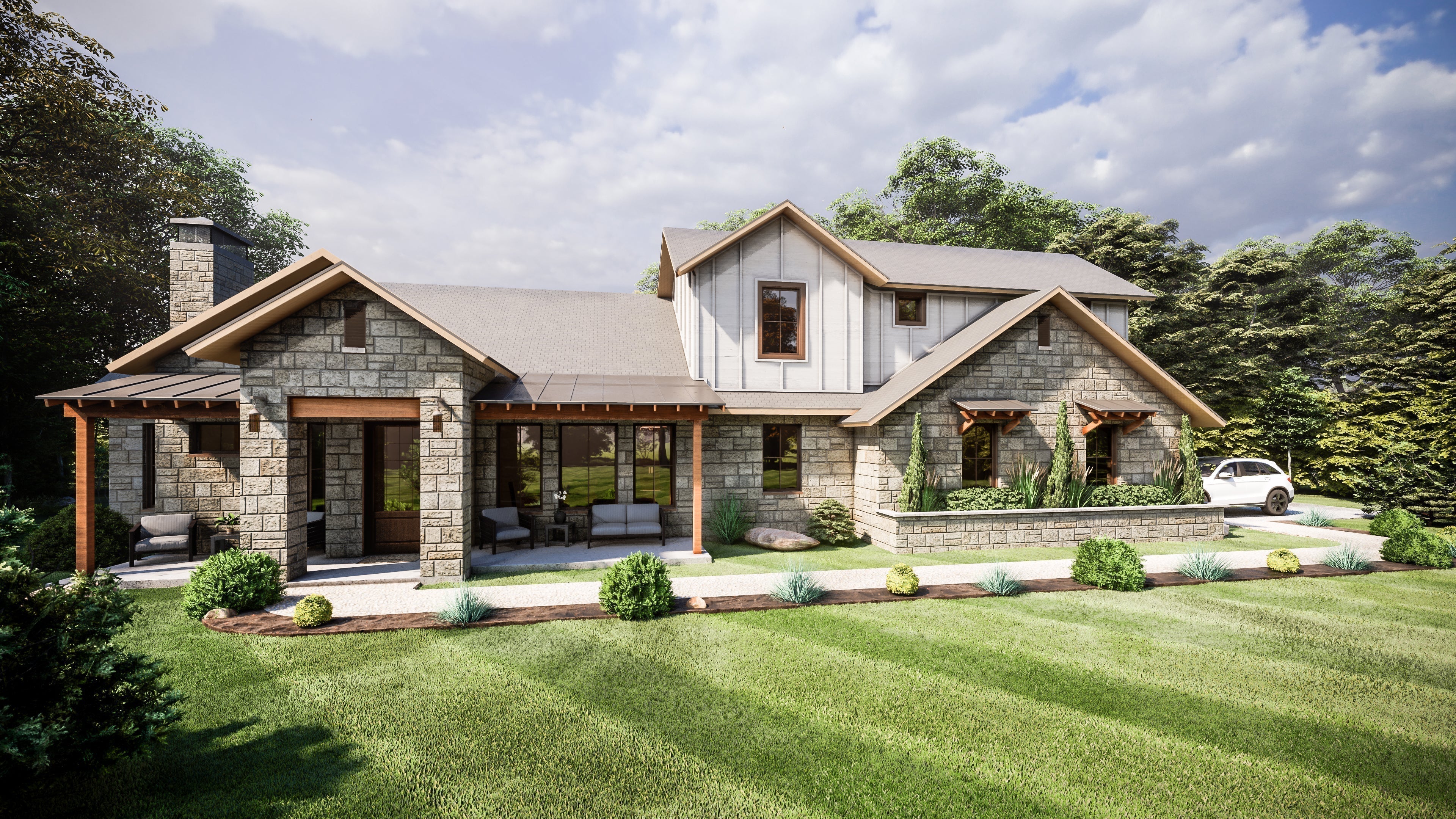 Stone modern farmhouse home with a covered porch, board-and-batten gable, and metal roof accents on a landscaped lot, designed by Fry Design Co.